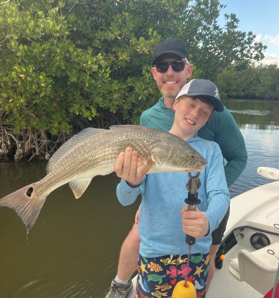 proud father and son with a great redfish caught near marco island